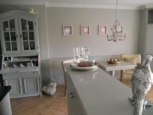 a kitchen with a table and a dining room at Ferienwohnung Sönshörn S8R In Munkmarsch in Munkmarsch +12 photos