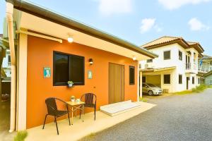 a house with a table and chairs in front of it at Dalbit Heaven #Patong Beach 3 min walk Super Private House 2BR in Patong Beach