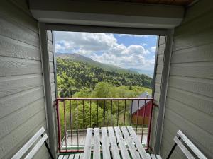 a balcony with a bench and a view of the mountains at Bel appartement duplex proche des pistes avec balcon et parking - FR-1-787-16 in Saint-Jacques-des-Blats