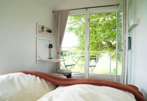 a bedroom with a bed and a sliding glass door at Studio Mini in Oersberg
