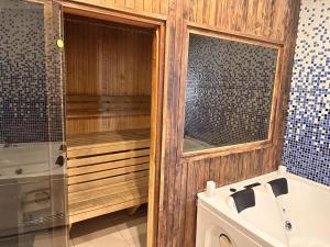 a bathroom with a tub and a sink and a shower at Skyhouse Riga Relax Penthouse And Spa in Rīga