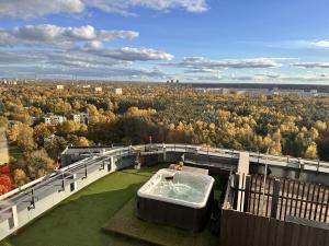 a hot tub on the balcony of a building at Skyhouse Riga Relax Penthouse And Spa in Rīga