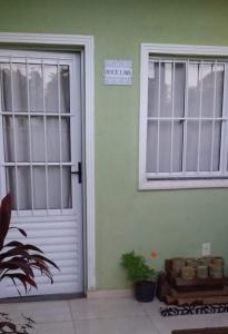 a door and a window on a house at Natureza e conforto na Praia da Brisa in Pedra de Guaratiba