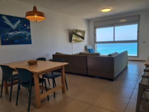 a living room with a table and a couch at Albi Boutique Apartments in ‘Akko +22 photos