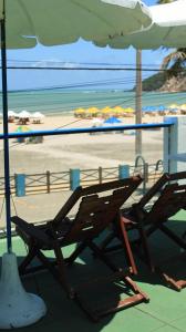 two chairs sitting under an umbrella on a beach at Ponta Negra Suites & Apart in Natal +146 photos
