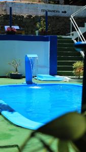 a swimming pool with a fountain in the middle at Ponta Negra Suites & Apart in Natal