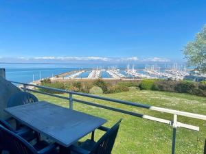 a picnic table on a balcony with a view of a marina at Quiberon - Appartement Triplex 73m² - 6 pers - Vue mer - FR-1-478-80 in Quiberon