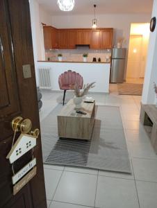 a living room with a coffee table and a kitchen at Misty Place in Ioannina
