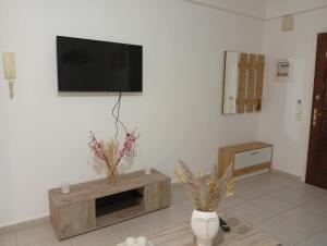 a living room with a flat screen tv on a wall at Misty Place in Ioannina +6 photos