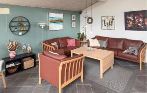 a living room with a couch and a table at Cozy Home In Tarm With Sauna in Højsand