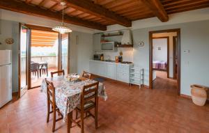 a kitchen and dining room with a table and chairs at Seranna 3 in Papiano