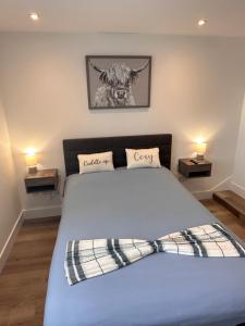 a bedroom with a bed with two night stands at Stā by The Bridge, Inverness City Centre in Inverness