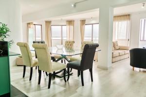 a dining room with a glass table and chairs at Buenavista Las Canteras in Las Palmas de Gran Canaria +29 photos