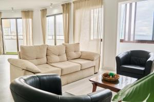 a living room with a couch and two chairs at Buenavista Las Canteras in Las Palmas de Gran Canaria