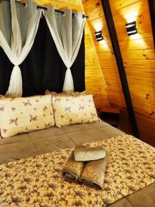 a bed in a room with curtains and a bed sidx sidx sidx at Chalé Passione in Gramado