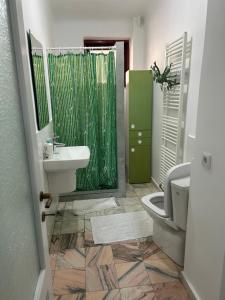 a bathroom with a sink and a toilet and a shower at Stela's Home in Ploieşti +4 photos