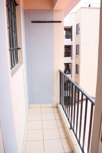 a balcony with a door in a building at Solace Park Apartments in Gatunga