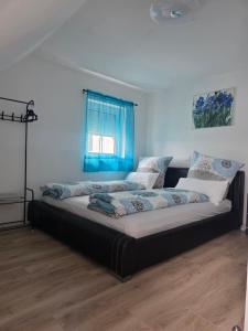 a large bed in a room with a blue window at S&P Dream Apartment in Backnang