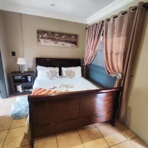 a bedroom with a bed and a window at Quiet Getaway in Bloemfontein +11 photos
