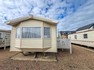 une petite maison assise au-dessus d'une cour dans l'établissement Great Caravan For Hire By The Beach In Norfolk, By Hunstanton Beach Ref 13005L, à Hunstanton