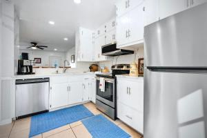 a kitchen with white cabinets and a stainless steel refrigerator at NEW Medical Professional Home Near Scott & White Medical and McClains Children Hospital in Temple