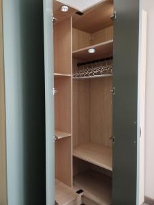 a walk in closet with a green door at À fleur de source in Mer