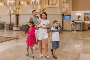 a family posing for a picture in a mall at Sunny Days Palma De Mirette Resort & Spa in Hurghada