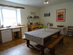 a kitchen with a table and a counter top at Baysdale Abbey in Battersby