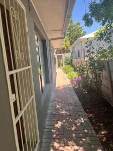 a brick walkway next to a building with a door at Riverside in Beaufort West +14 photos
