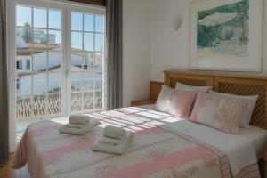 a bedroom with a bed with two towels on it at DBV Guesthouse in Lagos