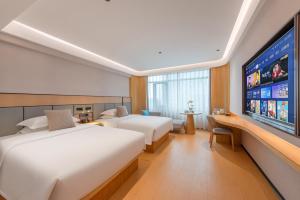 TV a/nebo společenská místnost v ubytování Foshan Shunde Beijiao Zhongyue International Hotel