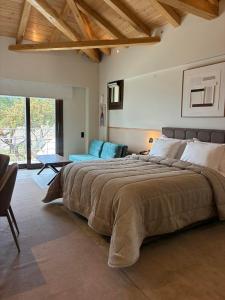 a bedroom with a large bed and a couch at Valeni Boutique Hotel & Spa in Portariá