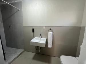 a bathroom with a sink and a toilet at Sunray Guesthouse in Newcastle
