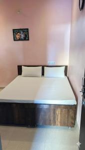 a bed in a small room with at Dwarka Home Stay 2 Only family in Dwarka