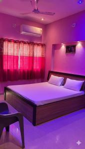 a bedroom with a large bed with purple lighting at Dwarka Home Stay 2 Only family in Dwarka
