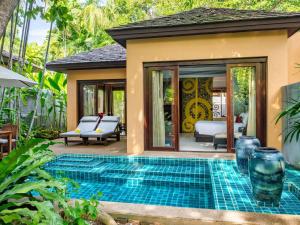 a pool in the backyard of a villa at Mövenpick Asara Resort & Spa Hua Hin in Hua Hin