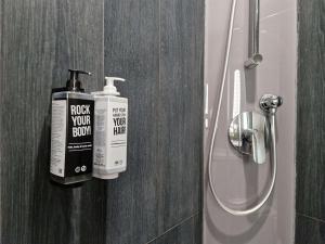 a bathroom with a bottle of soap next to a shower at Ibis Aktobe in Aktobe