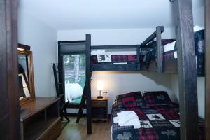 a bedroom with two bunk beds and a mirror at Blue Haven home in Killington Village