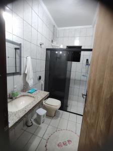 a bathroom with a toilet and a sink at Hostel Castelo in Belo Horizonte