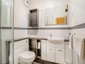 a bathroom with a toilet and a sink at Marina View Apartment in Swansea +6 photos