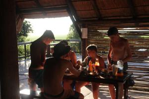 a group of people sitting around a table at Surf Stoke Cottage in Jeffreys Bay +17 photos