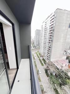 an apartment balcony with a view of a city at La Foret in Lima