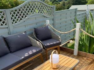 a patio with two chairs and a couch and a table at Oakleigh in Old Brampton +3 photos