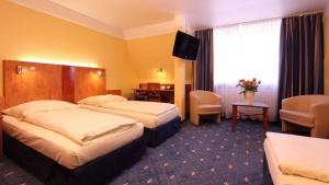 Postel nebo postele na pokoji v ubytování Aparthotel Astro - Nichtraucherhotel