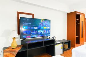 a living room with a large flat screen tv at The Grand Imperial in Ban Song Hong