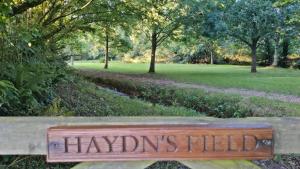 a sign that reads hydrantsfield sitting on a park bench at The Tuckers Arms in Dalwood +1 photo
