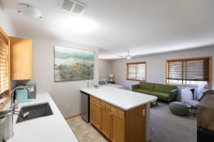 a kitchen and living room with a couch and a table at The Oaks in Lyle +28 photos