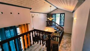 a winding staircase in a home with windows at Lake and Paddy holiday home in Alleppey