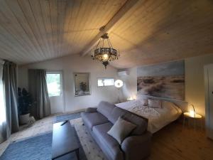 a living room with a bed and a couch at The old henhouse in Tenhult