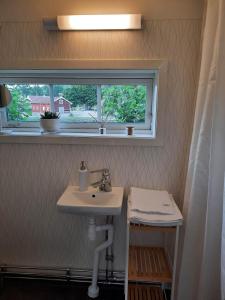 a bathroom with a sink and a window at The old henhouse in Tenhult